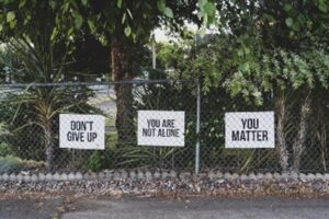 Images of signs saying dont give up, you are not alone, you matter